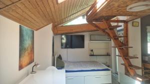 a small bedroom with a bed and a wooden ceiling at WOHLFÜHLOASE - Zimmer, Appartment - im Herzen STARNBERGS in Starnberg
