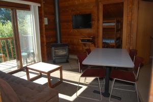 a living room with a table and a stove at La Conner Camping Resort Deluxe Cabin 5 in La Conner
