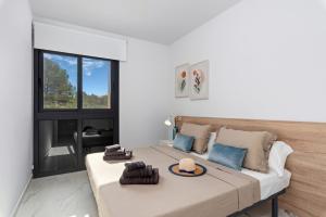 a bedroom with a large bed and a large window at Casa Azul in La Florida