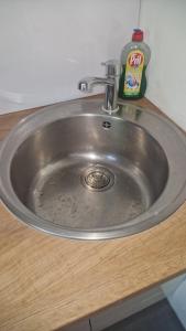 a silver sink in a counter with a bottle of soap at WOHLFÜHLOASE - Zimmer, Appartment - im Herzen STARNBERGS in Starnberg