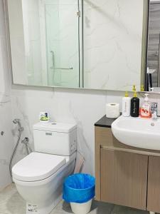 a bathroom with a toilet and a sink and a mirror at Homestay Agile At Bukit Bintang KL in Kuala Lumpur