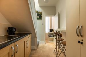a kitchen with a sink and a counter top at Stylish Urban Retreat- Fast WiFi & Private Ensuite in Bristol +8 photos