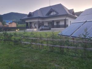 a house with solar panels in a yard at Mușata New in Vama