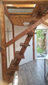 a wooden staircase in a room with a ceiling at WOHLFÜHLOASE - Zimmer, Appartment - im Herzen STARNBERGS in Starnberg