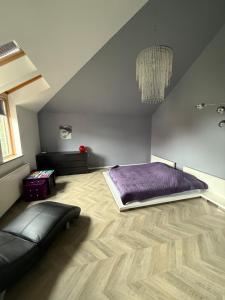 a bedroom with a bed and a couch in a room at Apartment SPA in Świnoujście