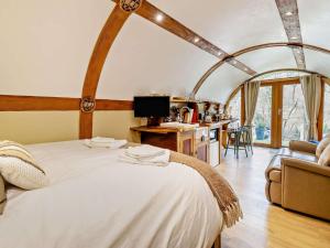 a bedroom with a large white bed and a desk at 1 Bed in Llanidloes 81415 in Van
