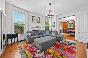 a living room with a couch and a rug at Historic 3-BR Downtown Bourbon Getaway in Louisville