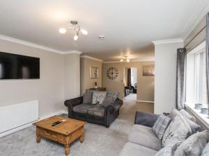 a living room with a couch and a table at Tennyson House in Scarborough