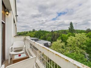 a white chair sitting on a balcony with a view at Panoramique du Bois de Vincennes à Paris, avec balcon terrasse in Saint-Maurice