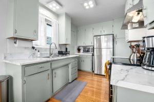 a kitchen with white cabinets and stainless steel appliances at Seabright Breeze in Santa Cruz