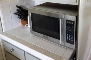 a microwave oven sitting on top of a kitchen counter at Seabright Breeze in Santa Cruz +26 photos