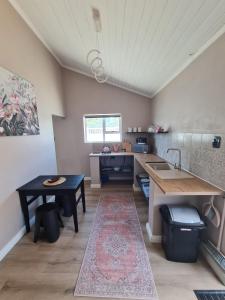 a kitchen with a table and a sink and a counter at LieBling Place in Cape Town