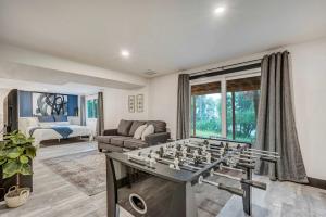 a living room with a chess board on a table at Oak Hills Estate Luxe Forest Escape Near USAFA in Monument