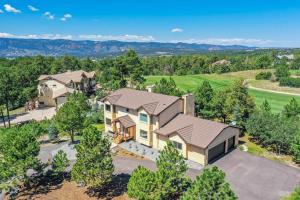 an aerial view of a house with a driveway at Oak Hills Estate Luxe Forest Escape Near USAFA in Monument
