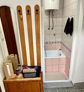a bathroom with a shower and a bath tub with a toilet and a sink at Vikendica Hondo Boracko jezero in Jezero +14 photos
