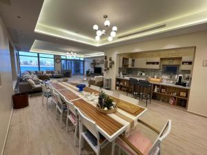 a kitchen and living room with a table and chairs at Soso beach villa in Durat Alarous