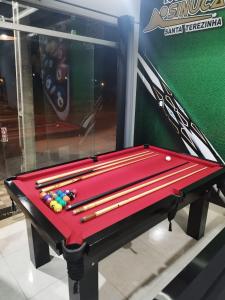 a red pool table with balls on top of it at Riviera Crispim - VERANEIO COM RIO in Itaporanga dʼAjuda +14 photos