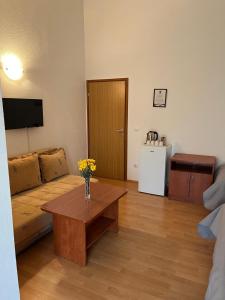 a living room with a couch and a table at Rooms Raguž in Neum
