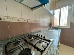 a kitchen with a stove top in a kitchen at Casablanca Central Suites - Casa Voyageurs in Casablanca