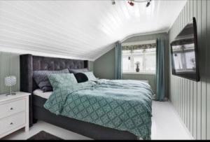 Un dormitorio con una cama con un edredón verde. en Summer place by the river, en Drammen