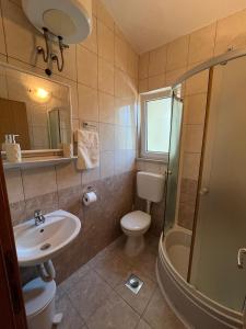 a bathroom with a sink and a toilet and a shower at Rooms Raguž in Neum +34 photos
