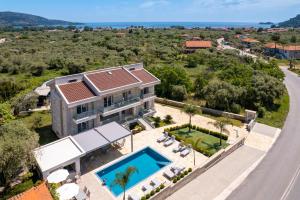 an aerial view of a house with a swimming pool at Supreme Luxury Suites in Skala Potamias