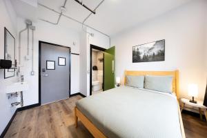 a bedroom with a large bed and a bathroom at Samesun Vancouver in Vancouver +36 photos
