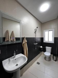 a bathroom with a sink and a toilet at Cozy Loft, Sunny Terrace in Nador +35 photos