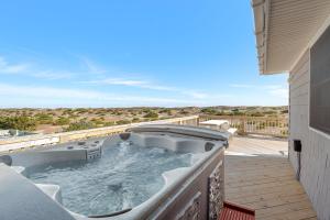 a hot tub on the deck of a house at Sandpiper in Salvo