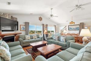 a living room with couches and a tv at Sandpiper in Salvo +39 photos
