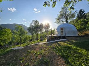 a large white tent on a grassy field at Kamp Glamp Plivska Oaza in Jajce +32 photos