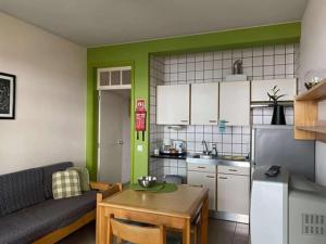 a kitchen with a couch and a table in a room at Hospedaria Verdemar in Horta
