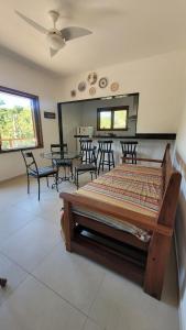 a bedroom with a bed and tables and chairs at Turtle house 1 in Búzios
