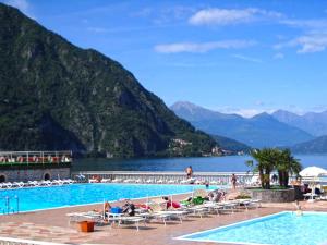 a swimming pool with a view of a lake and mountains at La Piazzetta in Menaggio