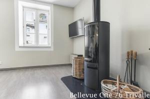 a kitchen with a black refrigerator and a window at Les Bellevue Cité Trivalle, Cité 500m, free private car park on demand, free public car park 200m, aircon, WIFI, Cité view terrace in Carcassonne