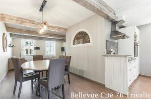 a kitchen and dining room with a table and chairs at Les Bellevue Cité Trivalle, Cité 500m, free private car park on demand, free public car park 200m, aircon, WIFI, Cité view terrace in Carcassonne