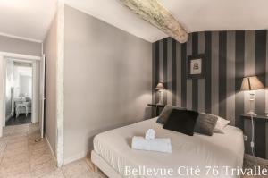 a bedroom with a bed with black and white stripes at Les Bellevue Cité Trivalle, Cité 500m, free private car park on demand, free public car park 200m, aircon, WIFI, Cité view terrace in Carcassonne