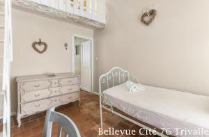 a bedroom with a white bed and a dresser at Les Bellevue Cité Trivalle, Cité 500m, free private car park on demand, free public car park 200m, aircon, WIFI, Cité view terrace in Carcassonne