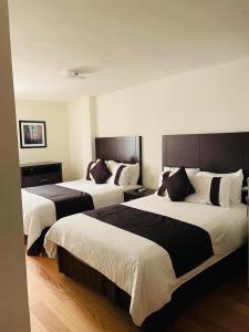Postel nebo postele na pokoji v ubytování Hotel Argento Zacatecas
