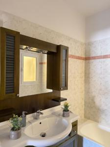 a bathroom with a sink and a mirror at Anemõessa in Korinthos +26 photos