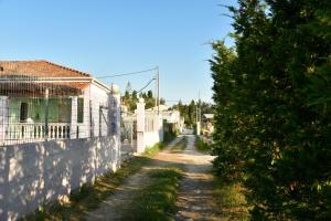 a dirt road in front of a house at 50 Steps From the Sea in Lefkimmi