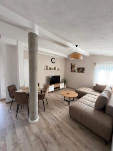 a living room with a couch and a table at Apartmani Krsto in Budva