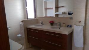 a bathroom with two sinks and a toilet and a mirror at Pensión Araba II in Vitoria-Gasteiz +52 photos