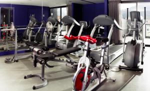 a gym with several tread machines in a room at Exe Bacata 95 in Bogotá