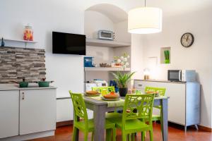a kitchen and dining room with a table and chairs at Martini Holiday's house in Altamura