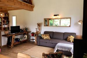 a living room with a couch and a window at Charmante maison à 5 minutes de la plage in Saint-Jean-de-Luz