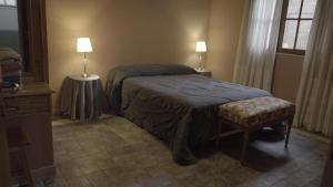 a bedroom with a bed and two lamps on two tables at Cabañas María CAROLINA in San Luis