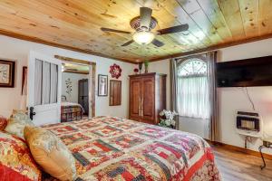 a bedroom with a bed and a ceiling fan at Riverfront Cabin - 6 Mi to Great Smoky Mtns NP! in Townsend