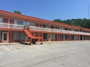 a large red building with a parking lot at Daniel Boone Motor Inn in Pikeville