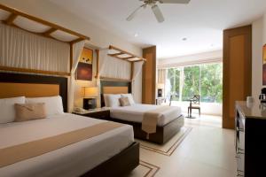a hotel room with two beds and a balcony at Kore Tulum Retreat & Spa Resort All Inclusive - Adults Only in Tulum